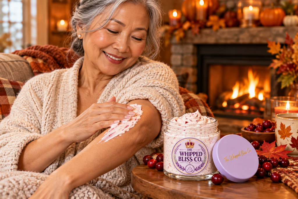 Woman applying Cranberry Harvest Body Butter by a cozy fireplace