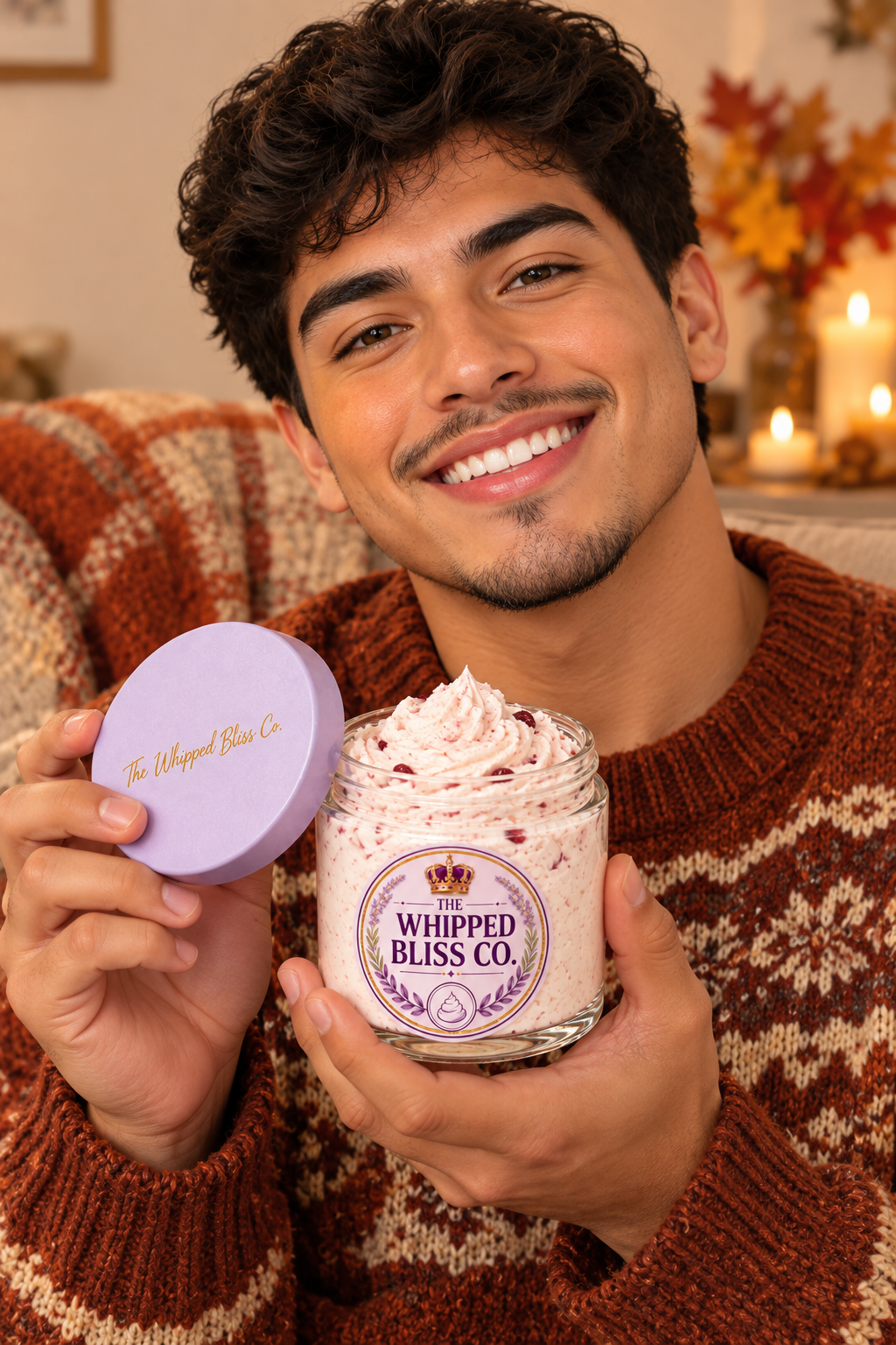 Young man holding Cranberry Harvest Body Butter jar for scale reference
