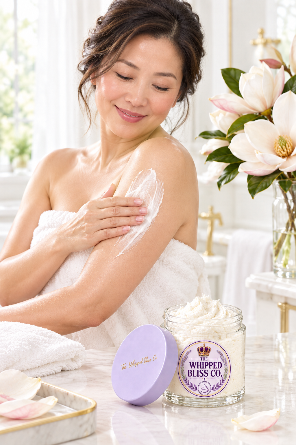 Woman applying Magnolia Body Butter in an elegant bathroom