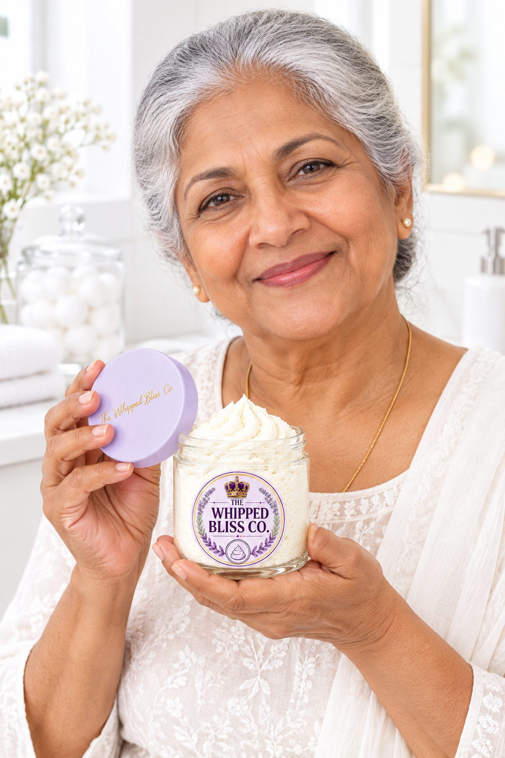 Elderly woman holding Baby Powder Body Butter jar for scale reference