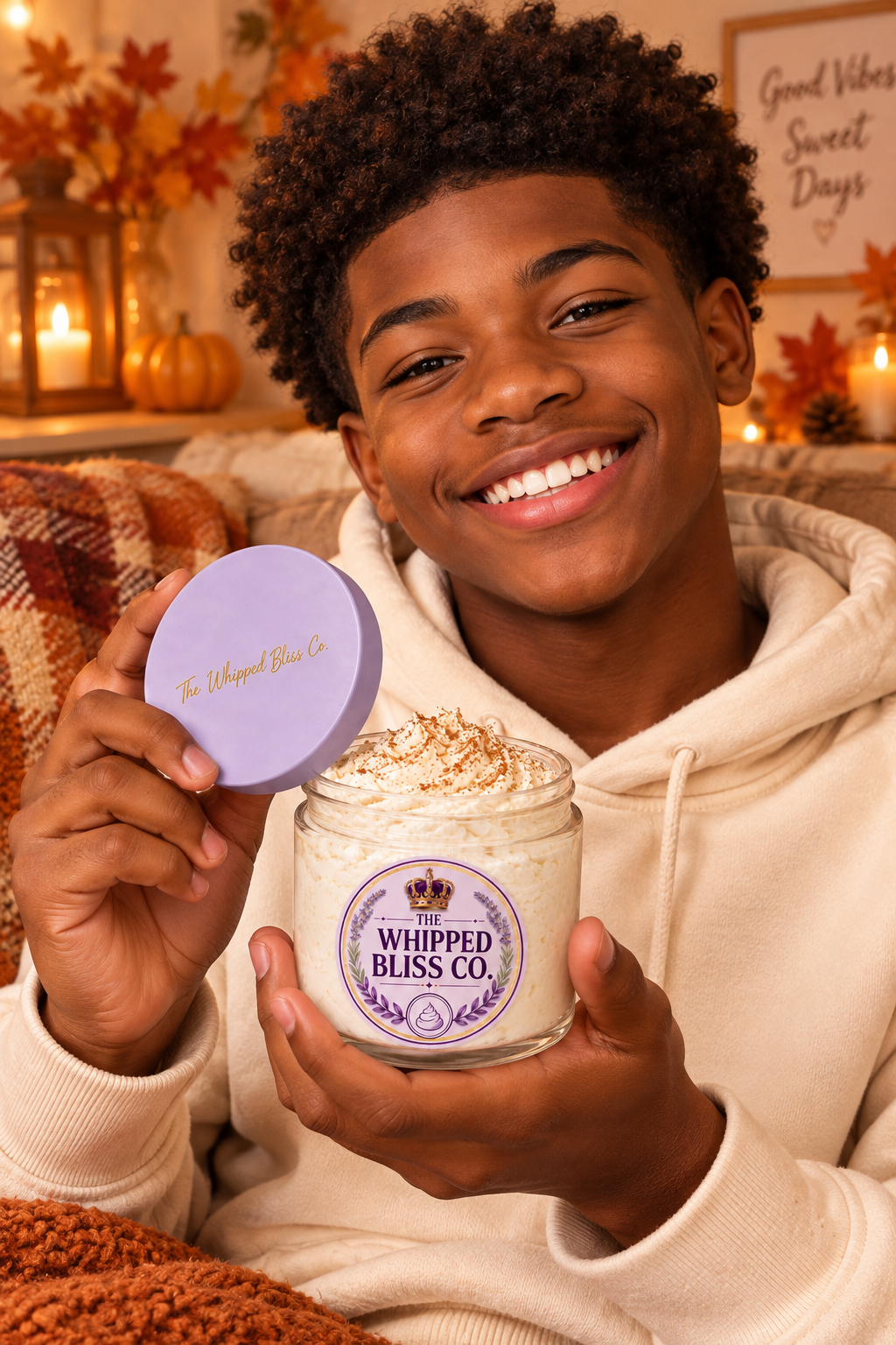 Teenage boy holding Apple Cider Donut Body Butter jar for scale reference